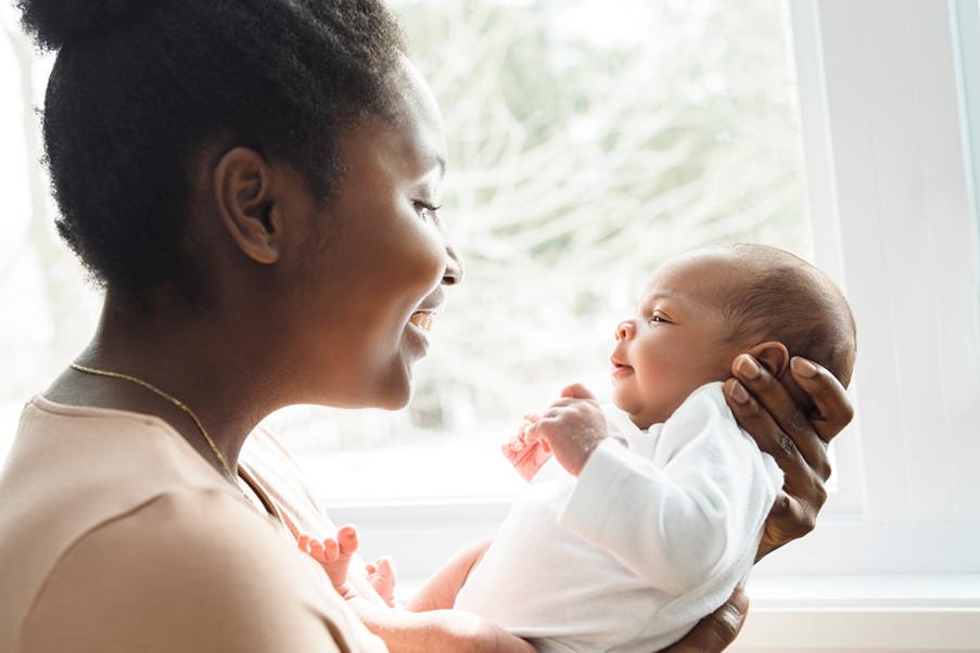 Portrait of a beautiful black mother, with her nursing baby